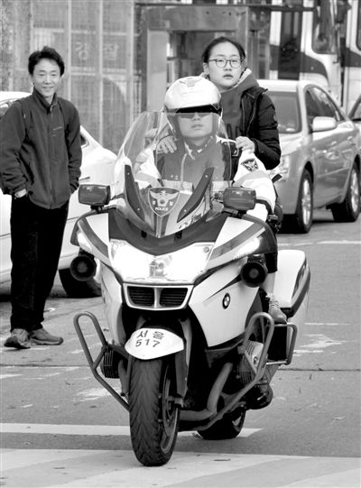 7日，首爾，警察將一名考生送抵考場。新華社發(fā)